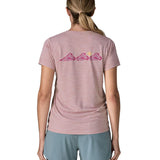 Woman wearing the Patagonia women's capilene t-shirt in violet that sits below the hips with pink trailcheck graphic across the back. 