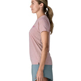 Woman wearing the Patagonia women's capilene t-shirt in violet that sits below the hips with a small black logo tag on the hem.