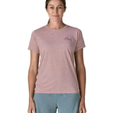 Woman wearing the Patagonia women's capilene t-shirt in violet with small pink trailcheck graphic on the chest.