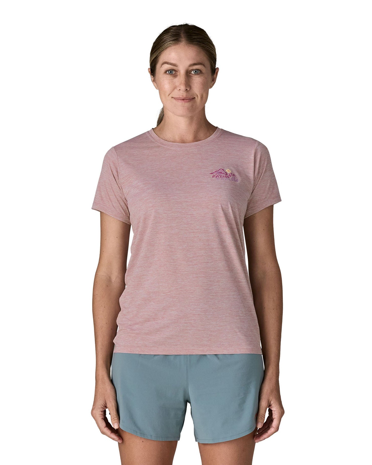 Woman wearing the Patagonia women's capilene t-shirt in violet with small pink trailcheck graphic on the chest.