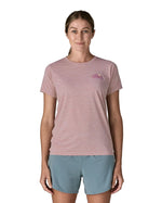 Woman wearing the Patagonia women's capilene t-shirt in violet with small pink trailcheck graphic on the chest.