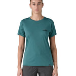 patagonia women's capilene top in a turquoise colour with logo design worn by a woman front detail