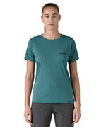 patagonia women's capilene top in a turquoise colour with logo design worn by a woman front detail