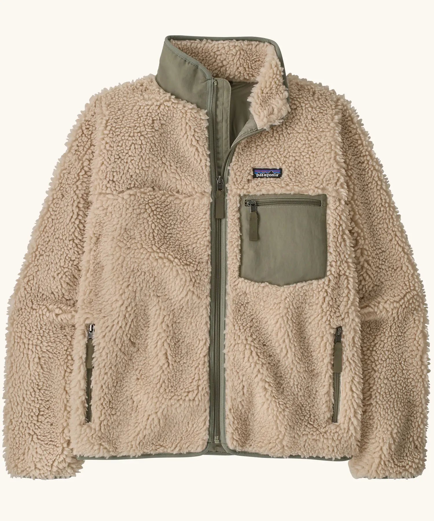 Patagonia Women's Classic Retro-X® fleece jacket in dark natural with green detailing.  Turn up collar, full length zip, 2 side handwarmer pockets and a green easy access chest pocket. 
