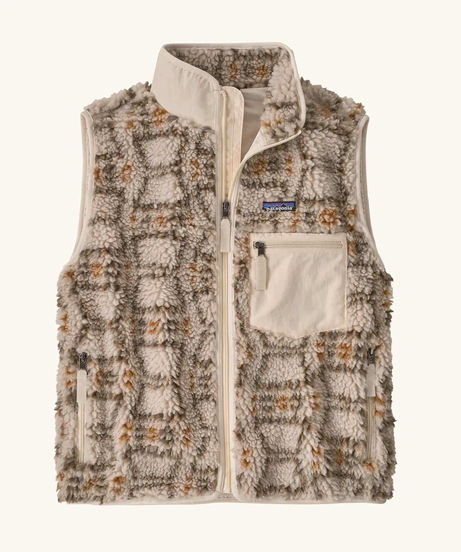 Patagonia women's classic Retro-X® fleece vest with a snowshoe hare pattern on natural. Full zip up front with zipped handwarmer pockets and zipped chest pocket.
