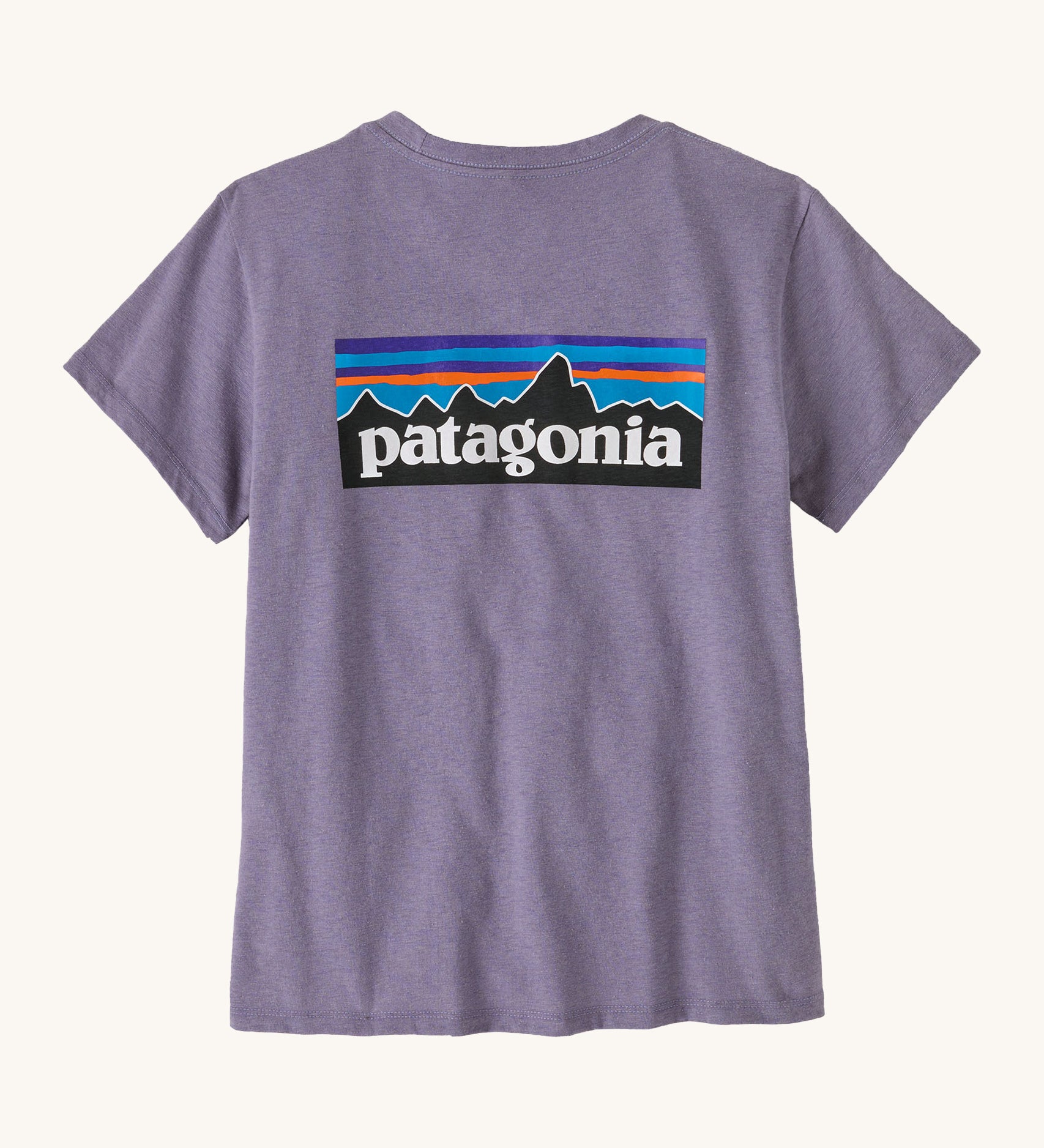 Patagonia women's short sleeve top in light purple back logo detail on a cream background.