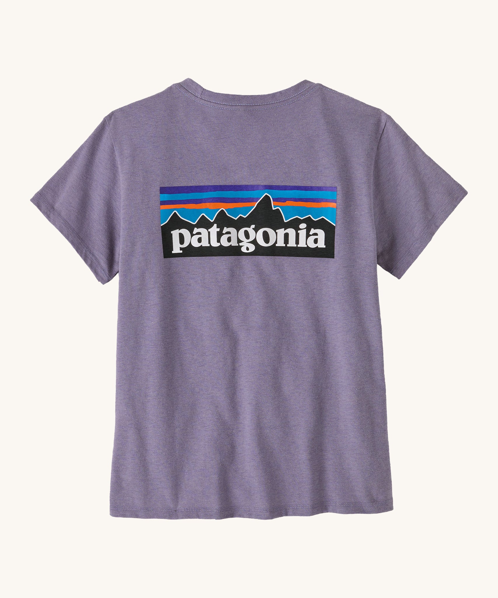 Patagonia women's short sleeve top in light purple back logo detail on a cream background.