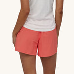 Close up of woman stood backwards wearing the Patagonia baggies shorts in the coral colour