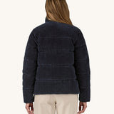 A view of the back of a woman wearing the Patagonia Women's Cord Fjord Down Insulated Jacket in a Sunken Blue colour.