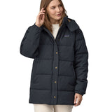 A woman wearing the Patagonia Women's Cotton Down Parka - Pitch Blue.