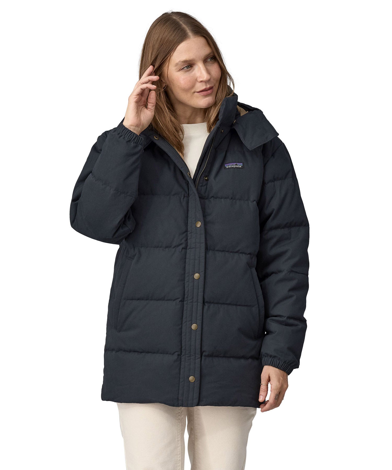 A woman wearing the Patagonia Women's Cotton Down Parka - Pitch Blue.