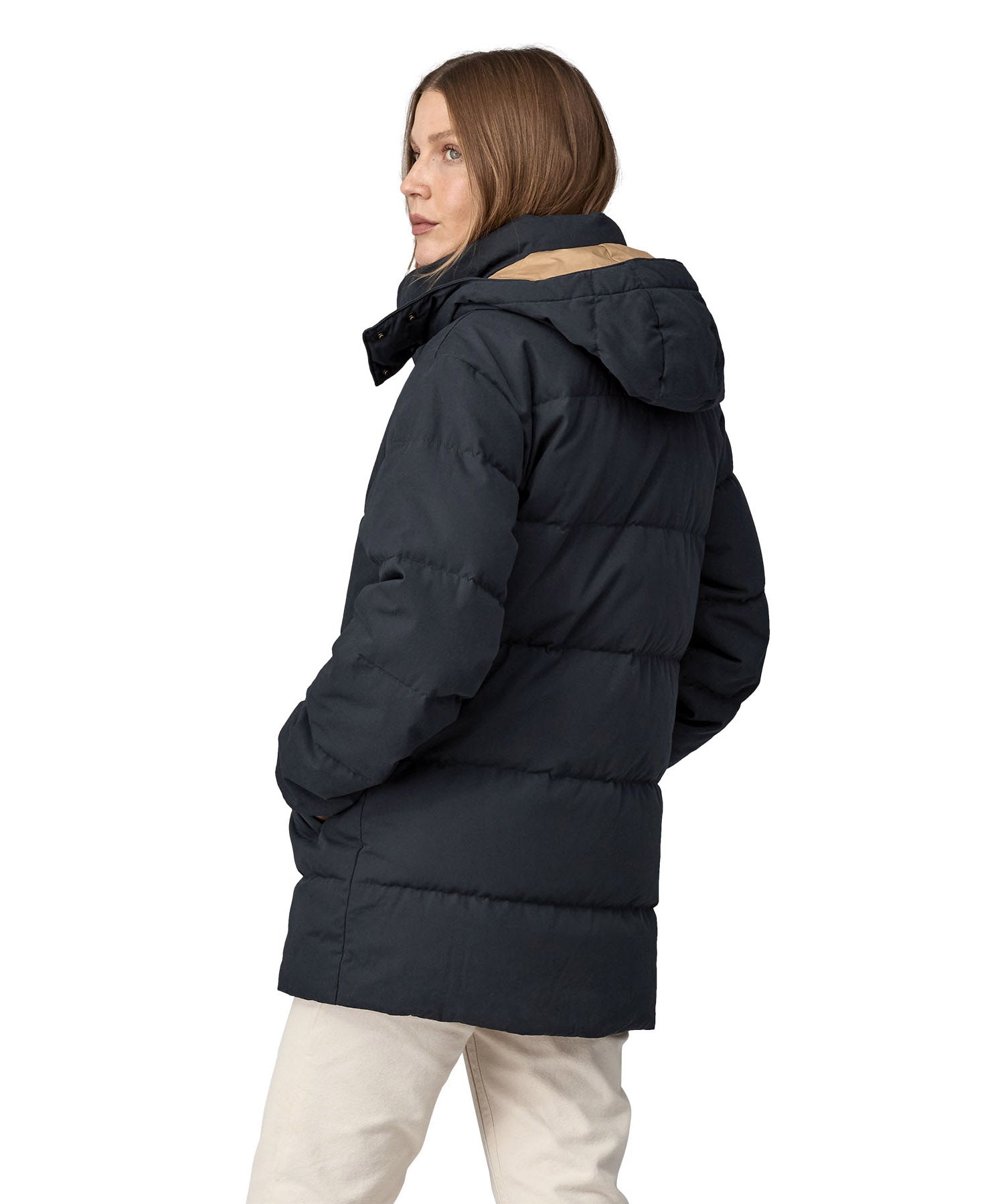A view of the back of a woman wearing the Patagonia Women's Cotton Down Parka - Pitch Blue