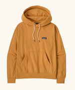 Patagonia women's cotton daily hoody in dried mango yellow with set-in sleeves, double lined hood, marsupial pocket and Patagonia® P-6 logo at the left chest. 