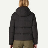 The back of the Patagonia women's Downdrift Jacket in black, worn by a model to showcase the fit. 