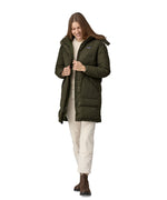 A woman wearing the Patagonia Women's Downdrift Parka in Pine Needle Green. The zip is fully open