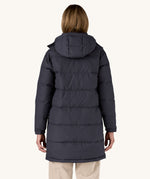 The back of a woman wearing the Patagonia Women's Downdrift Parka Jacket in a Sunken Blue colour.