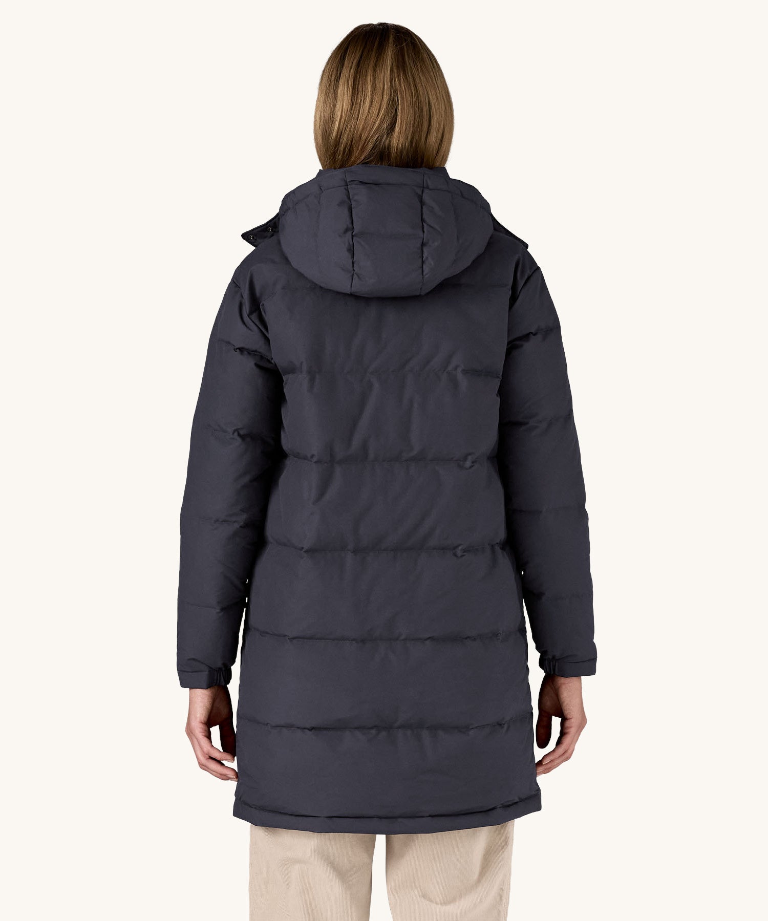 The back of a woman wearing the Patagonia Women's Downdrift Parka Jacket in a Sunken Blue colour.