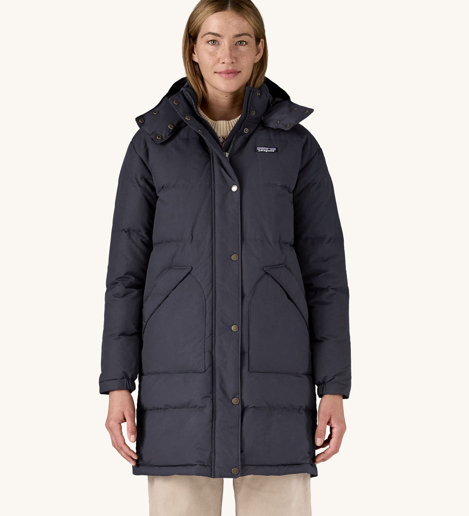 A woman wearing the Patagonia Women's Downdrift Parka Jacket in a Sunken Blue colour.