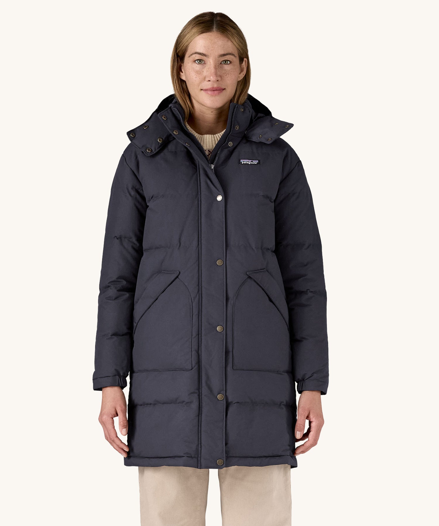 A woman wearing the Patagonia Women's Downdrift Parka Jacket in a Sunken Blue colour.
