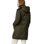 A view of the back of a woman wearing the Patagonia Women's Downdrift Parka in Pine Needle Green.