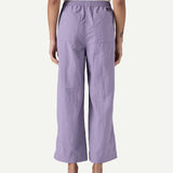 Back view of a model wearing Patagonia Women’s Outdoor Everyday Pants in purple, shown to demonstrate fit and length, with a high-rise elasticated waistband, wide-leg cropped cut, and two rear patch pockets.