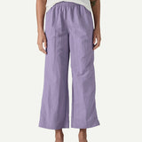 Front view of a model wearing Patagonia Women’s Outdoor Everyday Pants in purple to show fit, featuring a high-rise elasticated waist and wide-leg cropped silhouette falling above the ankles.