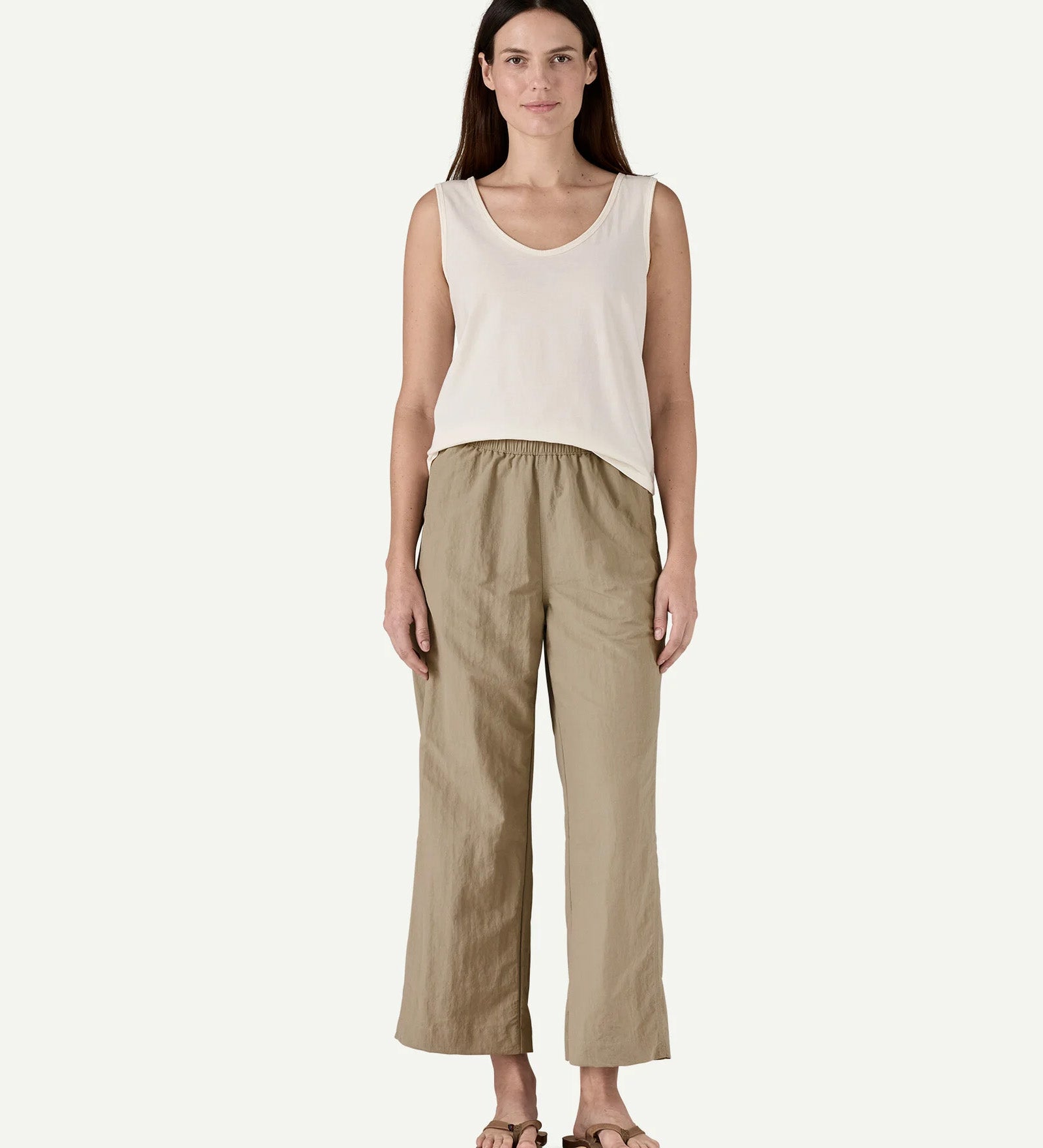 Front view of a model wearing Patagonia Women’s Outdoor Everyday Pants in Seabird Grey, showing a high-rise elasticated waistband and wide-leg cropped fit falling above the ankles.