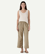 Front view of a model wearing Patagonia Women’s Outdoor Everyday Pants in Seabird Grey, showing a high-rise elasticated waistband and wide-leg cropped fit falling above the ankles.
