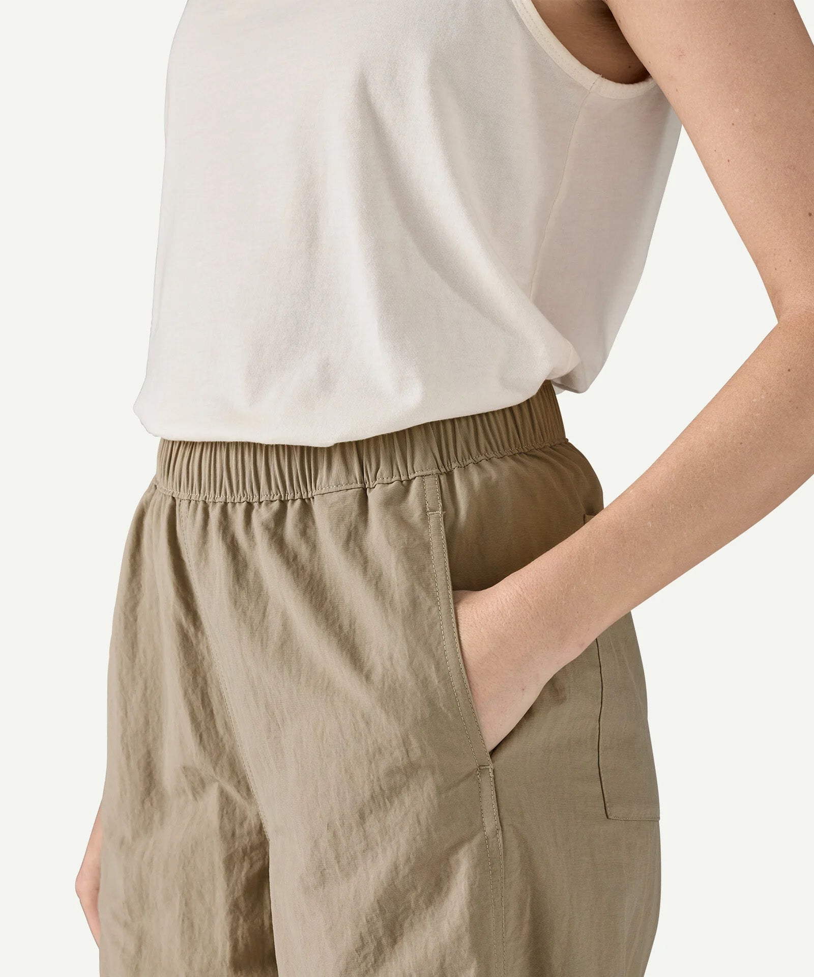 Close-up side view of Patagonia Women’s Outdoor Everyday Pants in Seabird Grey, showing the elasticated waistband, side-entry pocket, and lightweight nylon fabric texture.