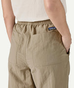 Angled back view of Patagonia Women’s Outdoor Everyday Pants in Seabird Grey, highlighting the elasticated waistband, rear patch pockets, and relaxed fit through the legs.