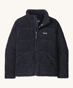 Patagonia women's Fjord jacket. A dark blue corduroy coat with a thick collar for warmth. Features 2 side pockets and a logo patch stitched on the left chest.