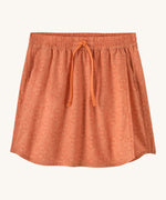 Patagonia women's fleetwith skort in a coral colour with flower design on a cream background.
