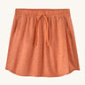 Patagonia women's fleetwith skort in a coral colour with flower design on a cream background.