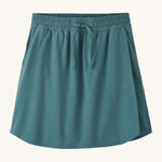Patagonia women's fleetwith skort in a teal colour on a cream background.