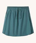 Patagonia women's fleetwith skort in a teal colour on a cream background.