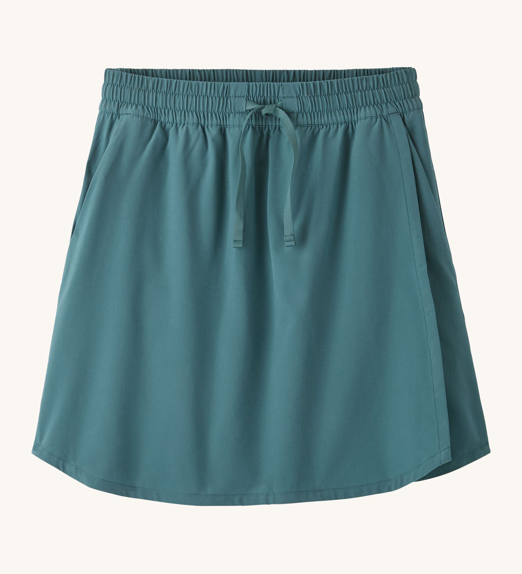 Patagonia women's fleetwith skort in a teal colour on a cream background.