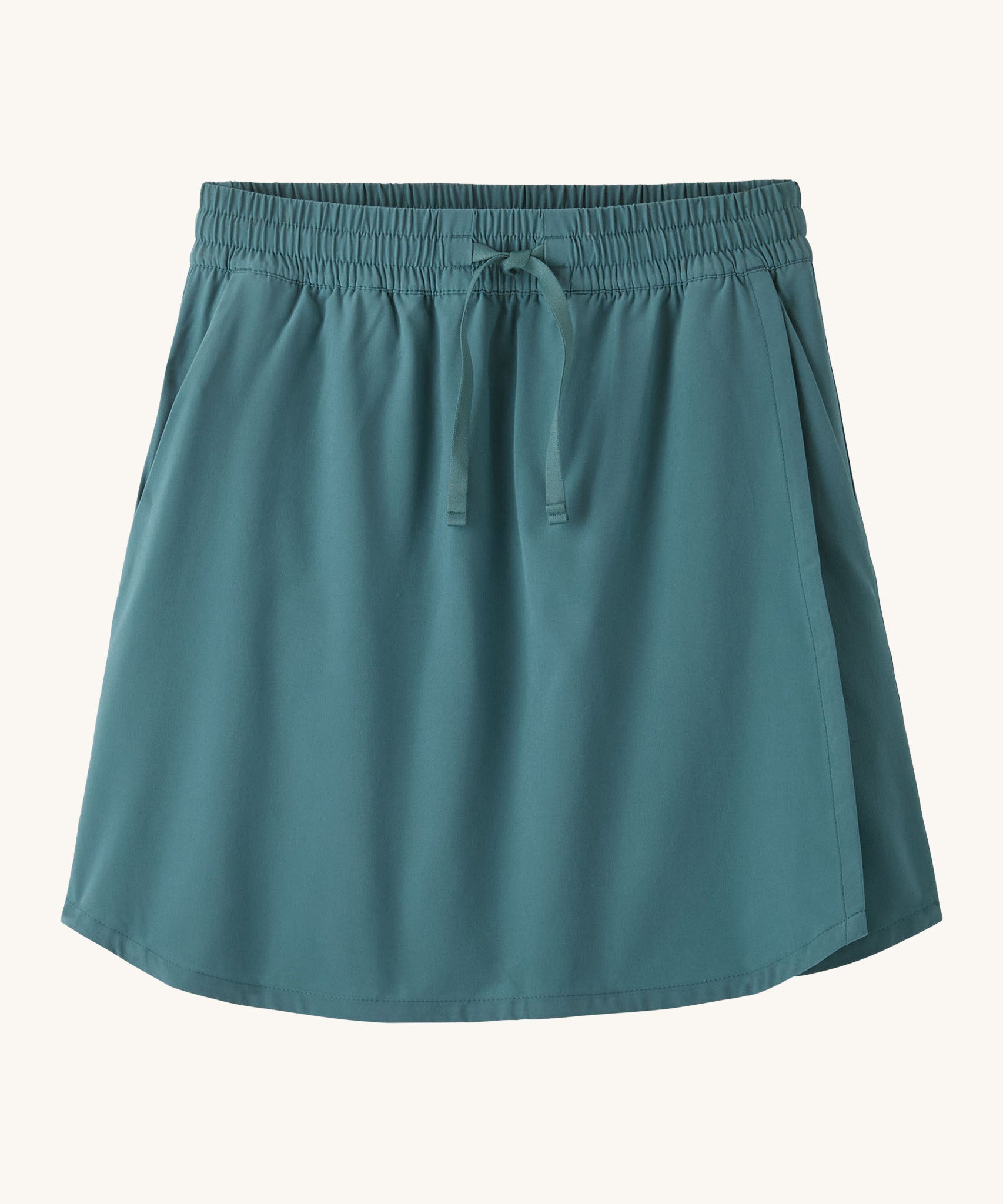 Patagonia women's fleetwith skort in a teal colour on a cream background.