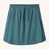 Patagonia women's fleetwith skort in a teal colour on a cream background.
