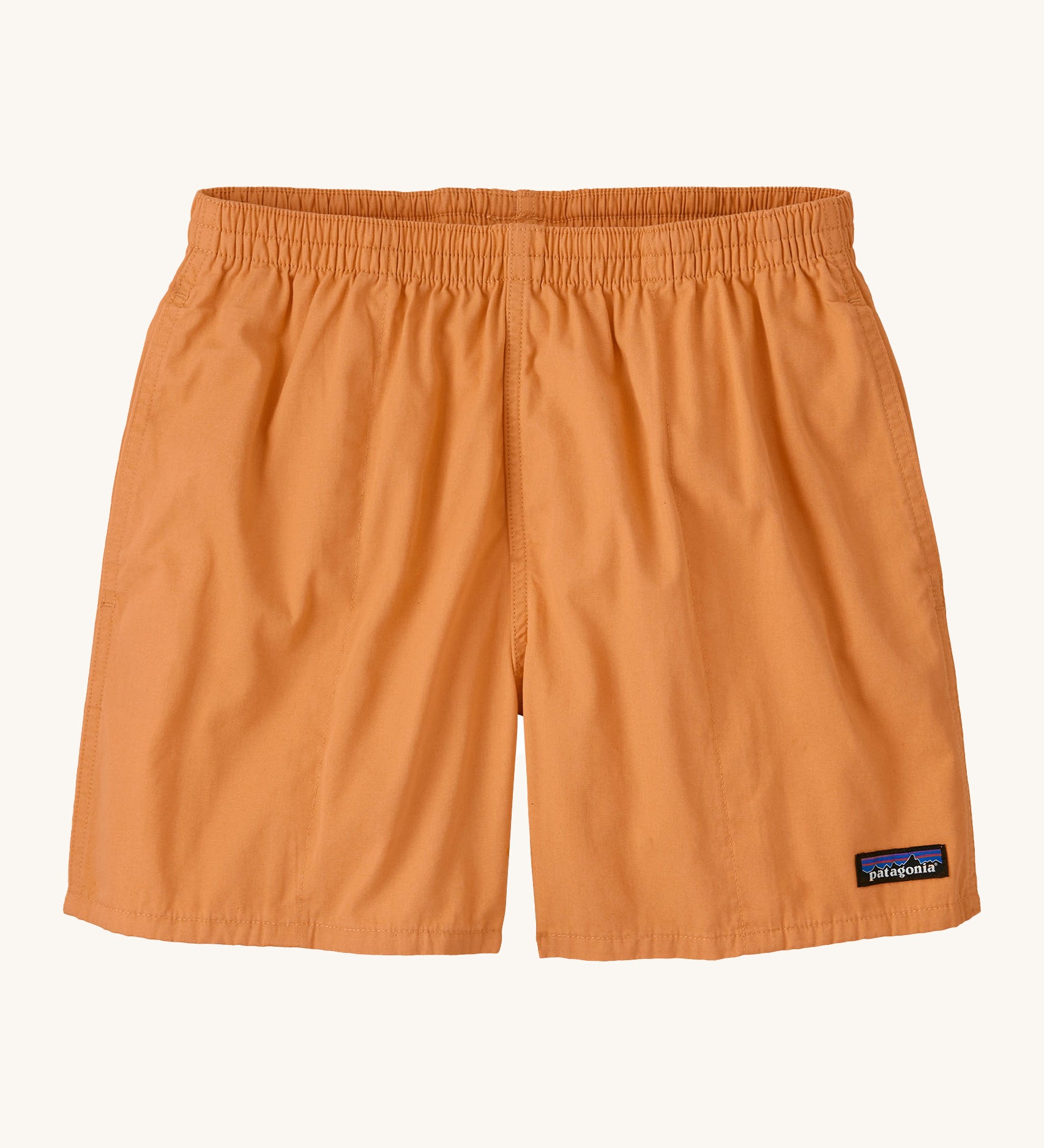 Patagonia women's funhogger shorts in dark peach on a cream background.
