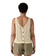 Woman wearing a Patagonia women's sleeveless garden island top in light cream whole weave material with the button up closure on the back.