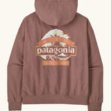 Back of the Patagonia women's great waves daily hoody in moonrise taupe. Large Patagonia logo on the back surrounded by waves and great pacific and iron works in sign style text. 
