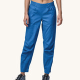 A person wearing a pair of Patagonia Women's Hampi Rock Pants in a blue colour.