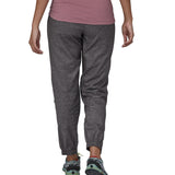 The back of the Patagonia women's hampi rock pants in regular ink black being worn. The length reaches just above the ankle.