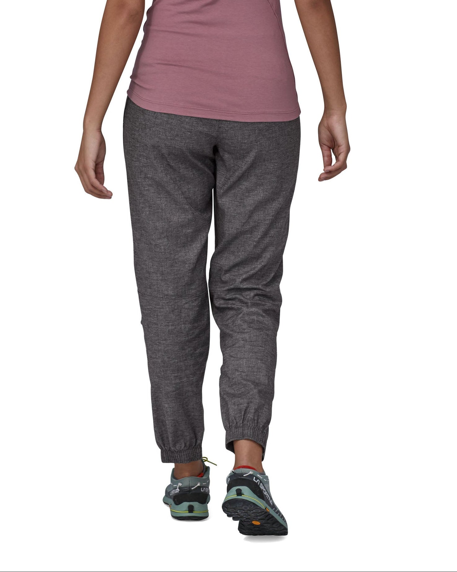The back of the Patagonia women's hampi rock pants in regular ink black being worn. The length reaches just above the ankle.