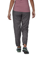 The back of the Patagonia women's hampi rock pants in regular ink black being worn. The length reaches just above the ankle.