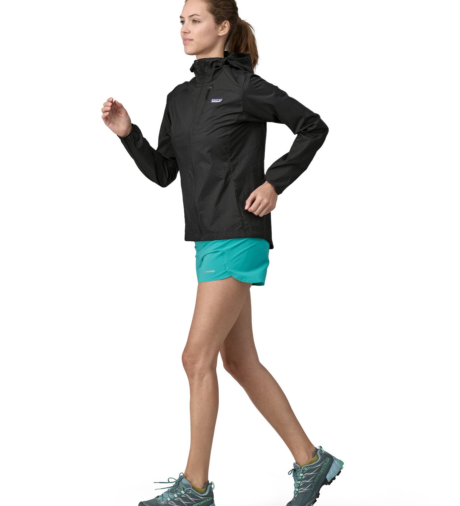 Patagonia women's houdini jacket in a back colour worn by a running woman