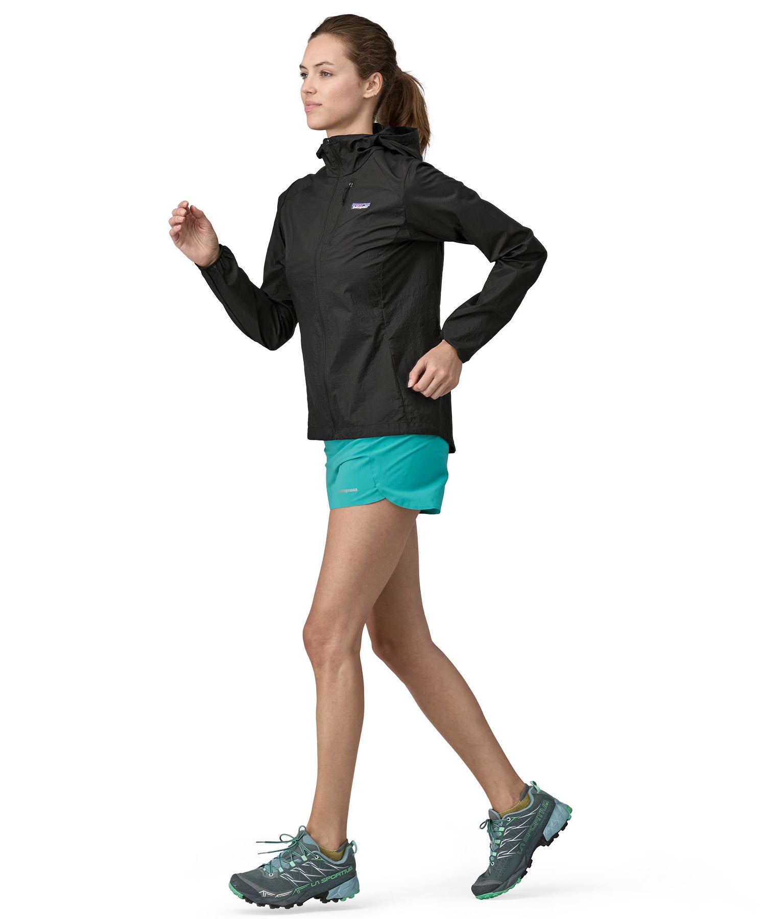 Patagonia women's houdini jacket in a back colour worn by a running woman
