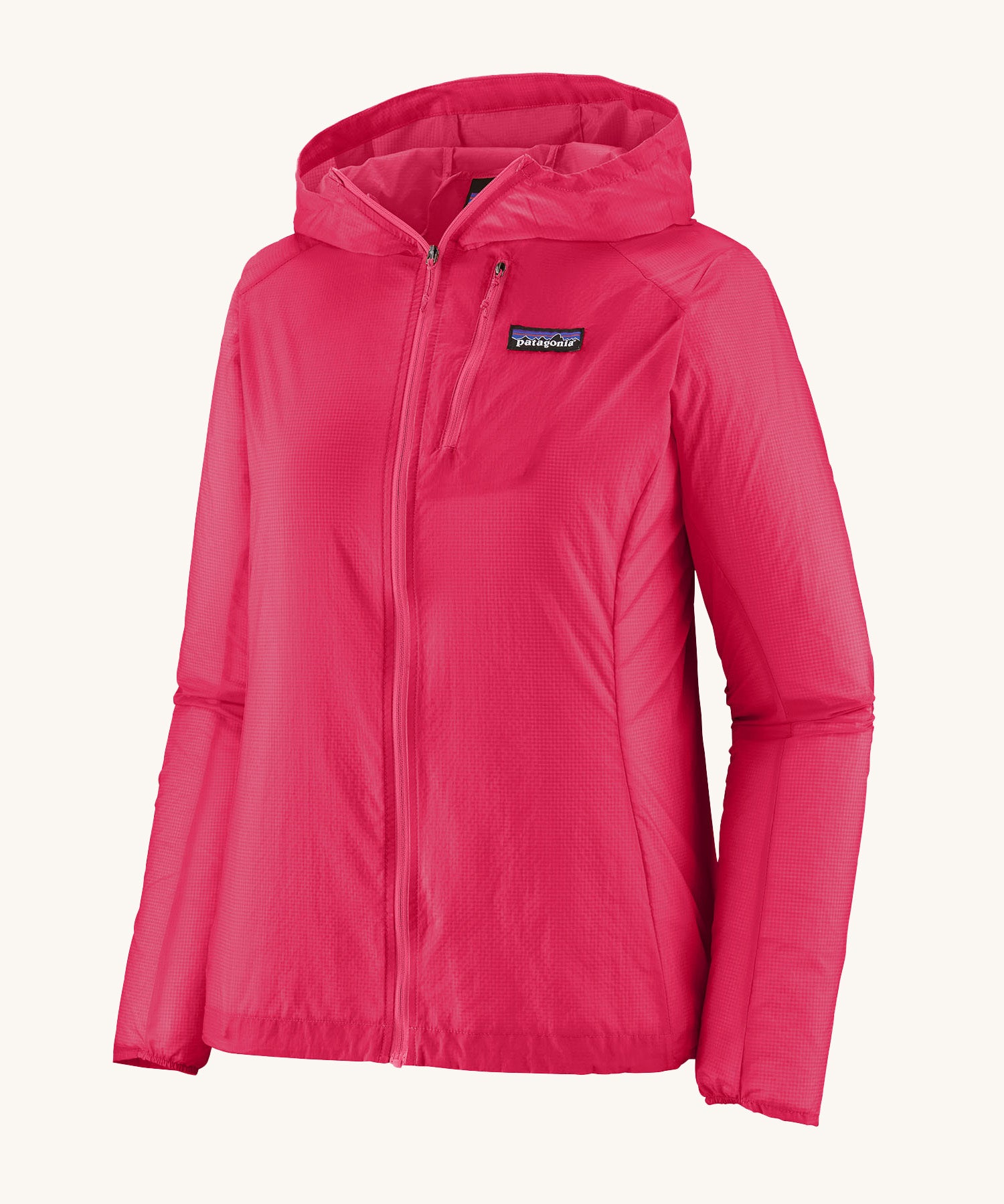 Patagonia womens houdini jacket in pink on a cream background.