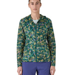 Patagonia women's houdini jacket in a turquoise colour with a retro flower design worn by a woman front detail