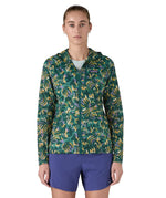 Patagonia women's houdini jacket in a turquoise colour with a retro flower design worn by a woman front detail